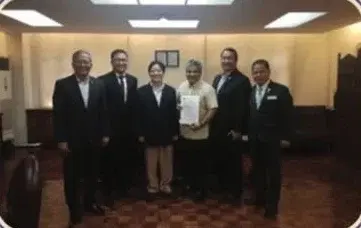 PDA officers holding the renewed certificate of accreditation